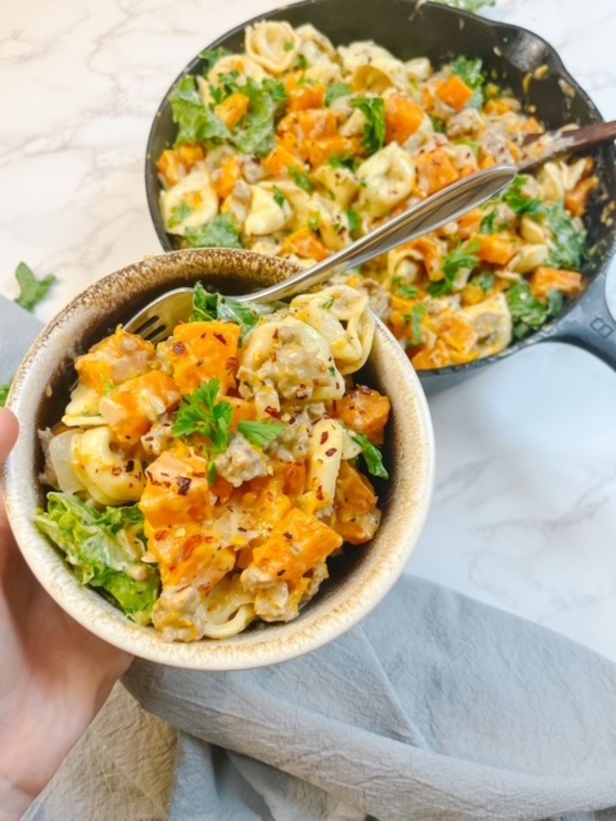 bowl of creamy roasted butternut squash, sausage, tortellini, and kale