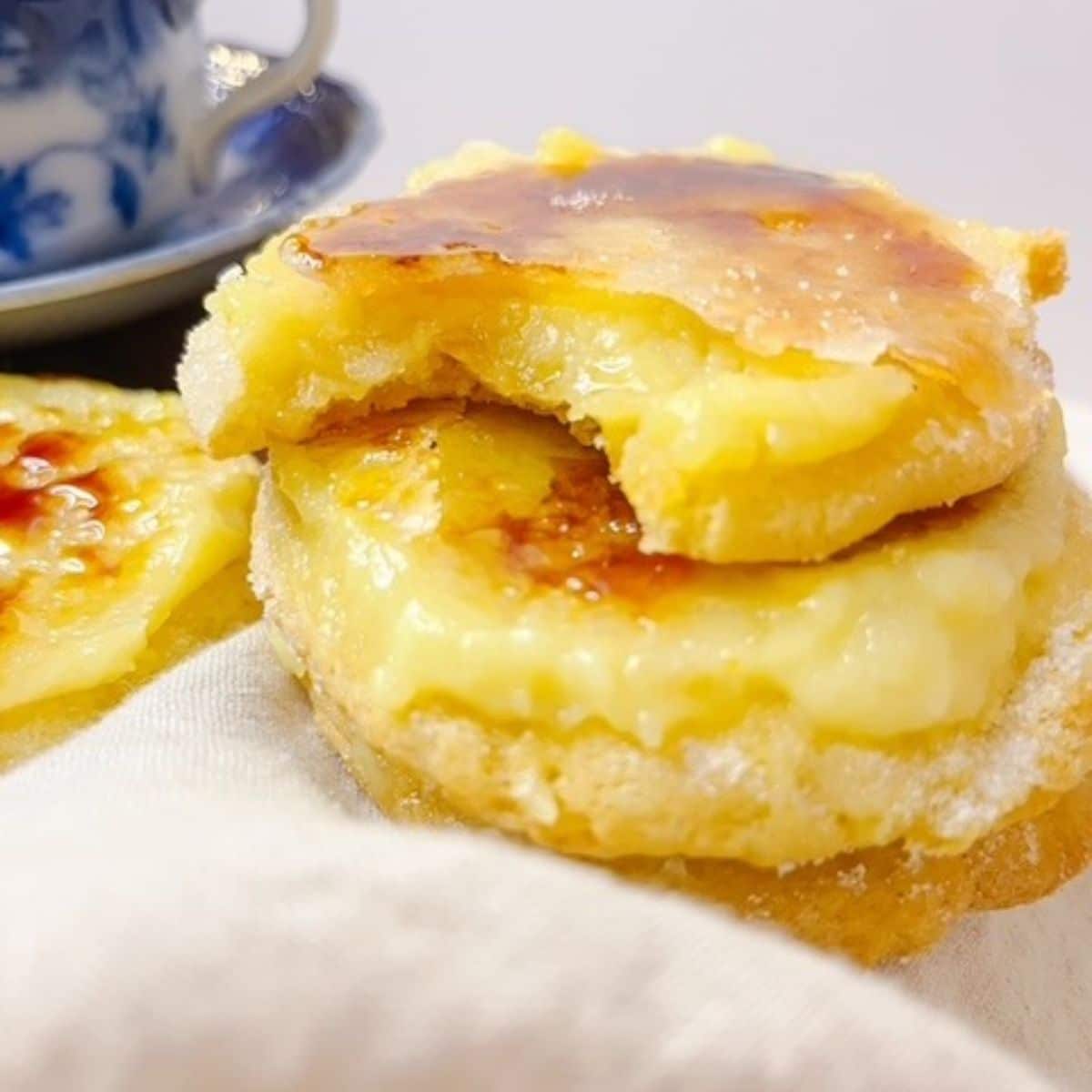 creme brule cookies stacked with a bite out of the top one