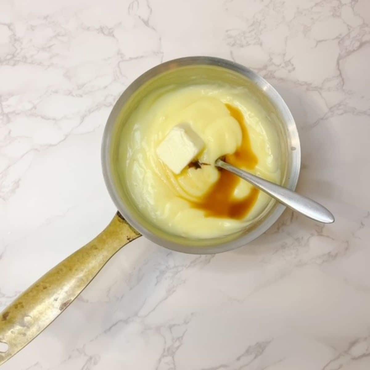 add butter and vanilla extract to the thickened pastry cream