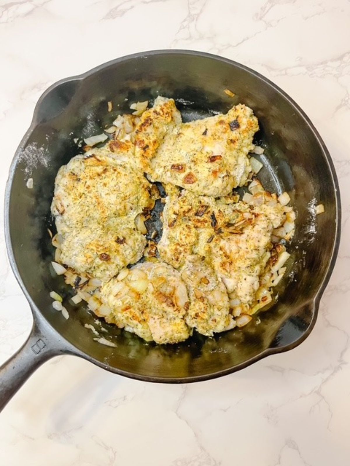 Brown the breaded chicken thighs on each side