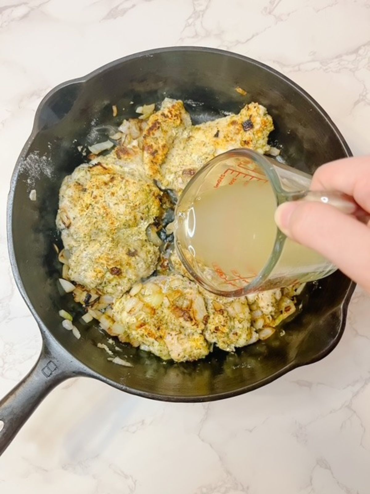 Add chicken broth to the skillet