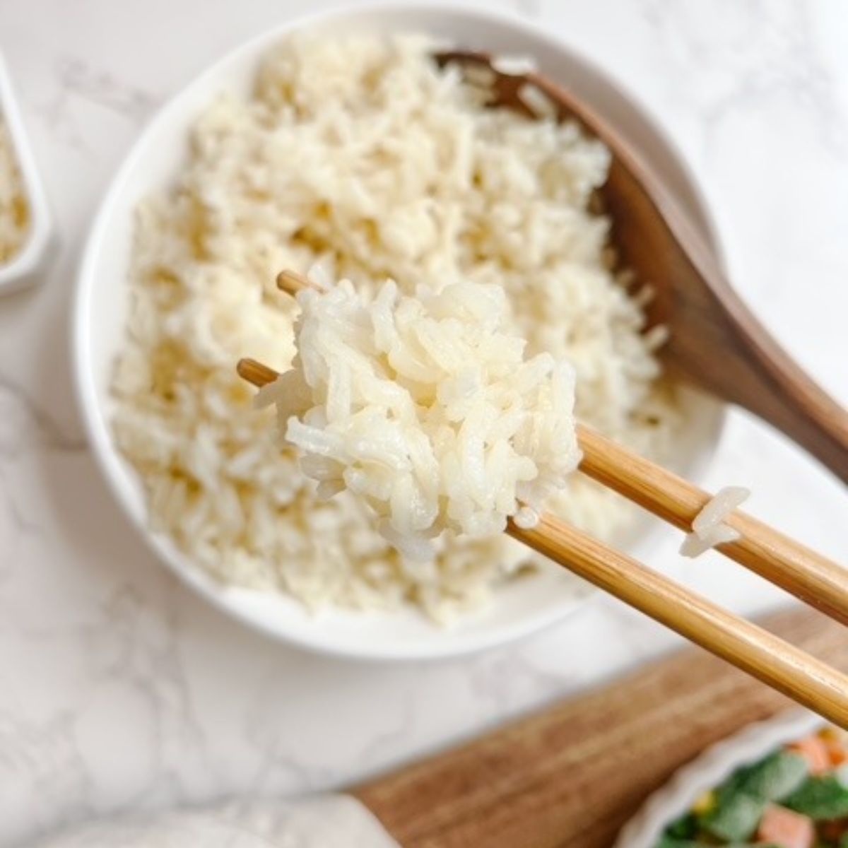 eating white rice with chopsticks
