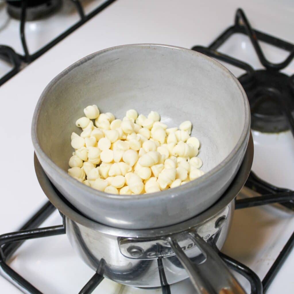 Melt white chocolate on a double broiler on the stove.