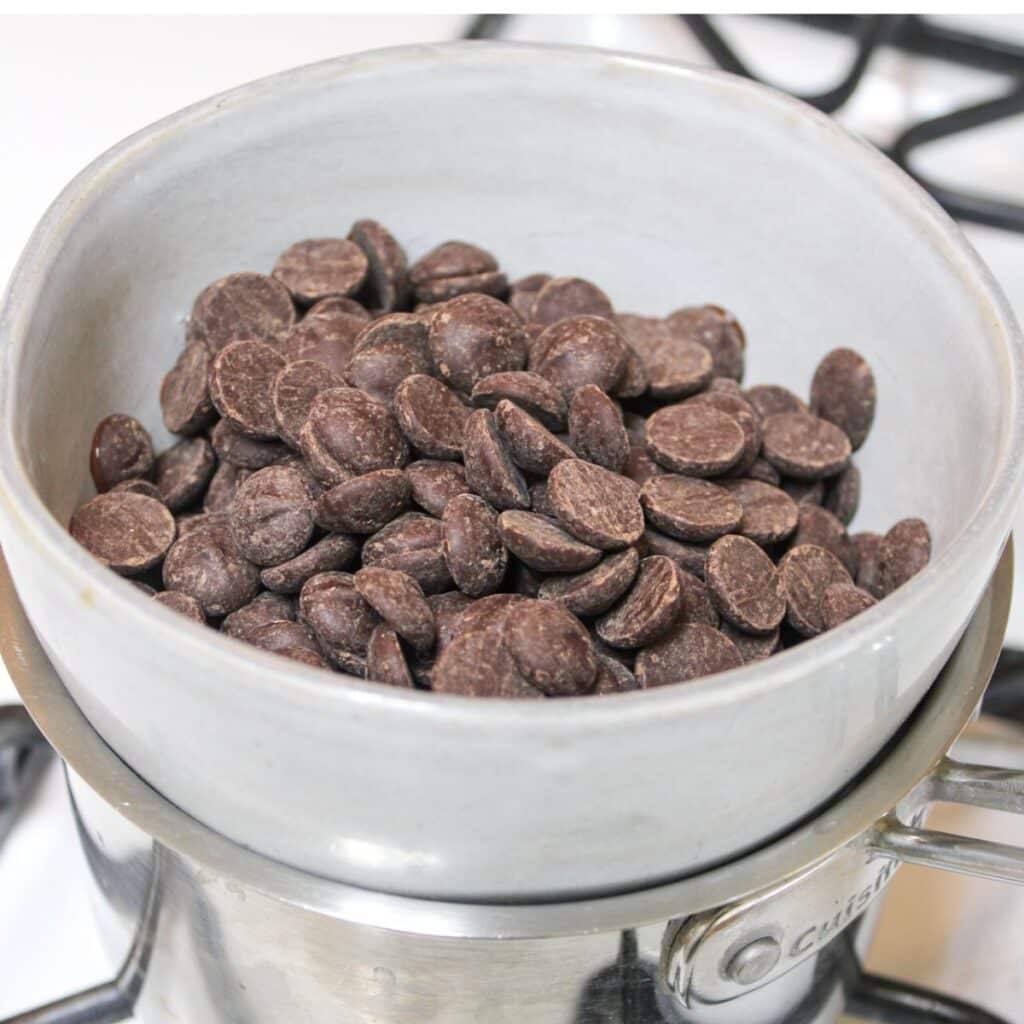 Put dark chocolate chips in a bowl on top of a pot over the stove to make a double broiler.