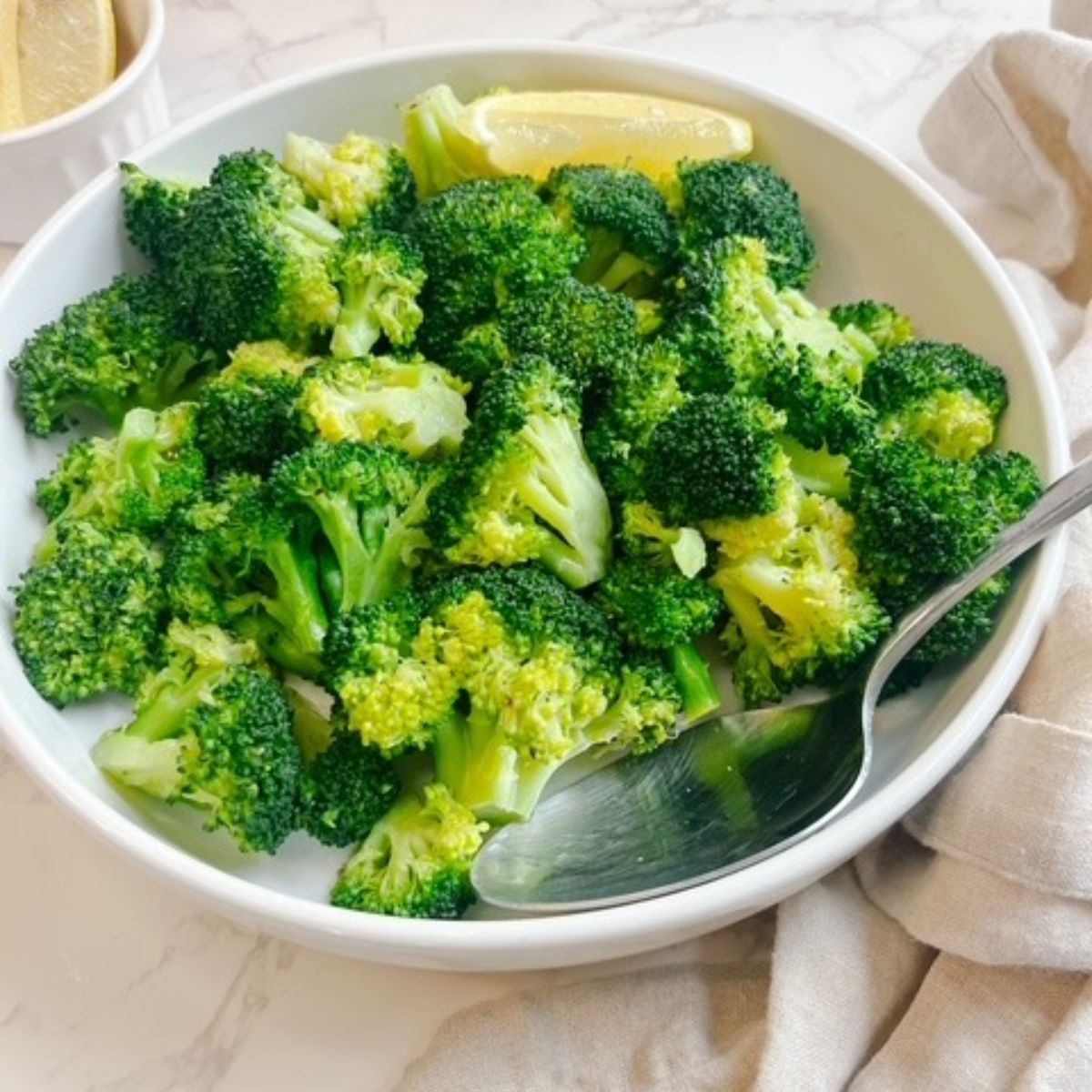 steamed broccoli with a lemon wedge