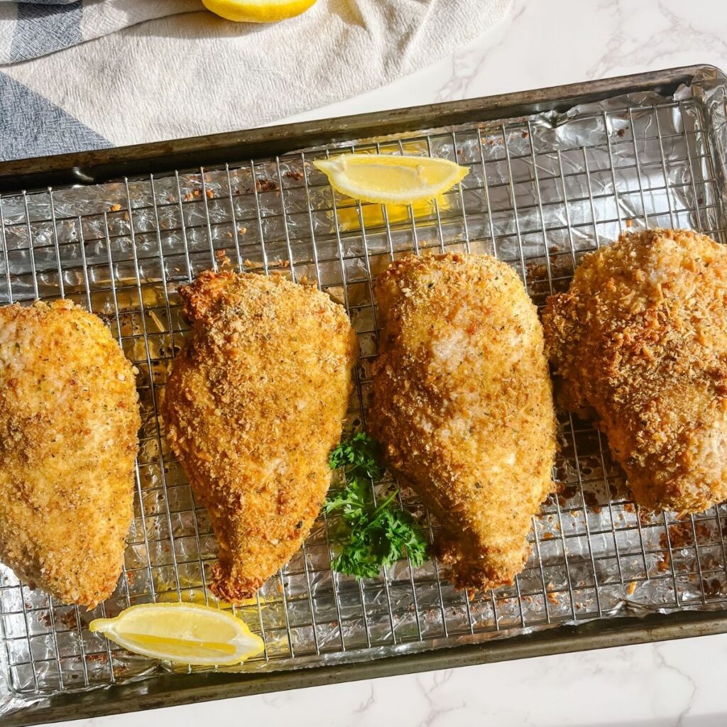 Place the chicken breasts on a baking sheet lined with aluminum foil and a grease tray.