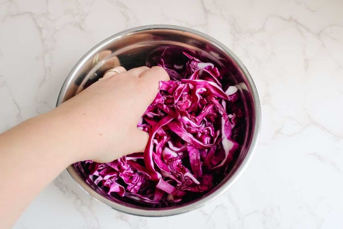 Add a bit of salt to sliced cabbage and massage with your hands