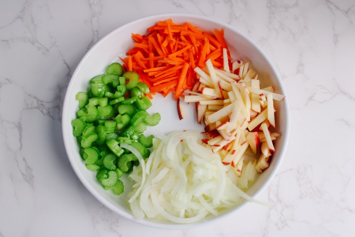 julienned carrots, apples, and onions and chopped celery for red cabbage salad