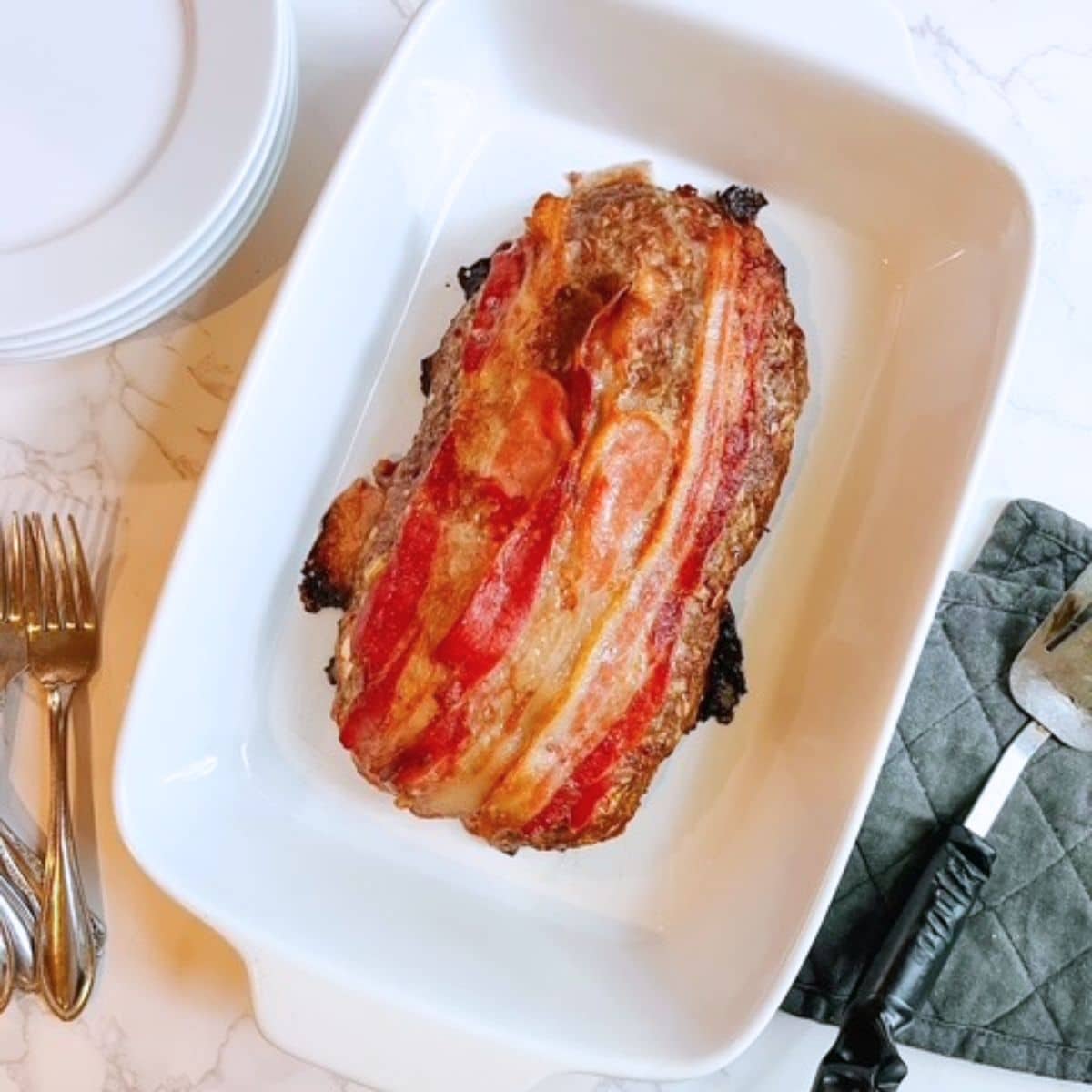 Bacon meatloaf will be golden brown with crispy golden bacon when it's done baking.