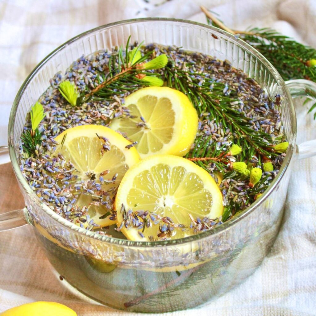 Create a simmer pot with lemon slices, rosemary sprigs, and fresh pine twigs.