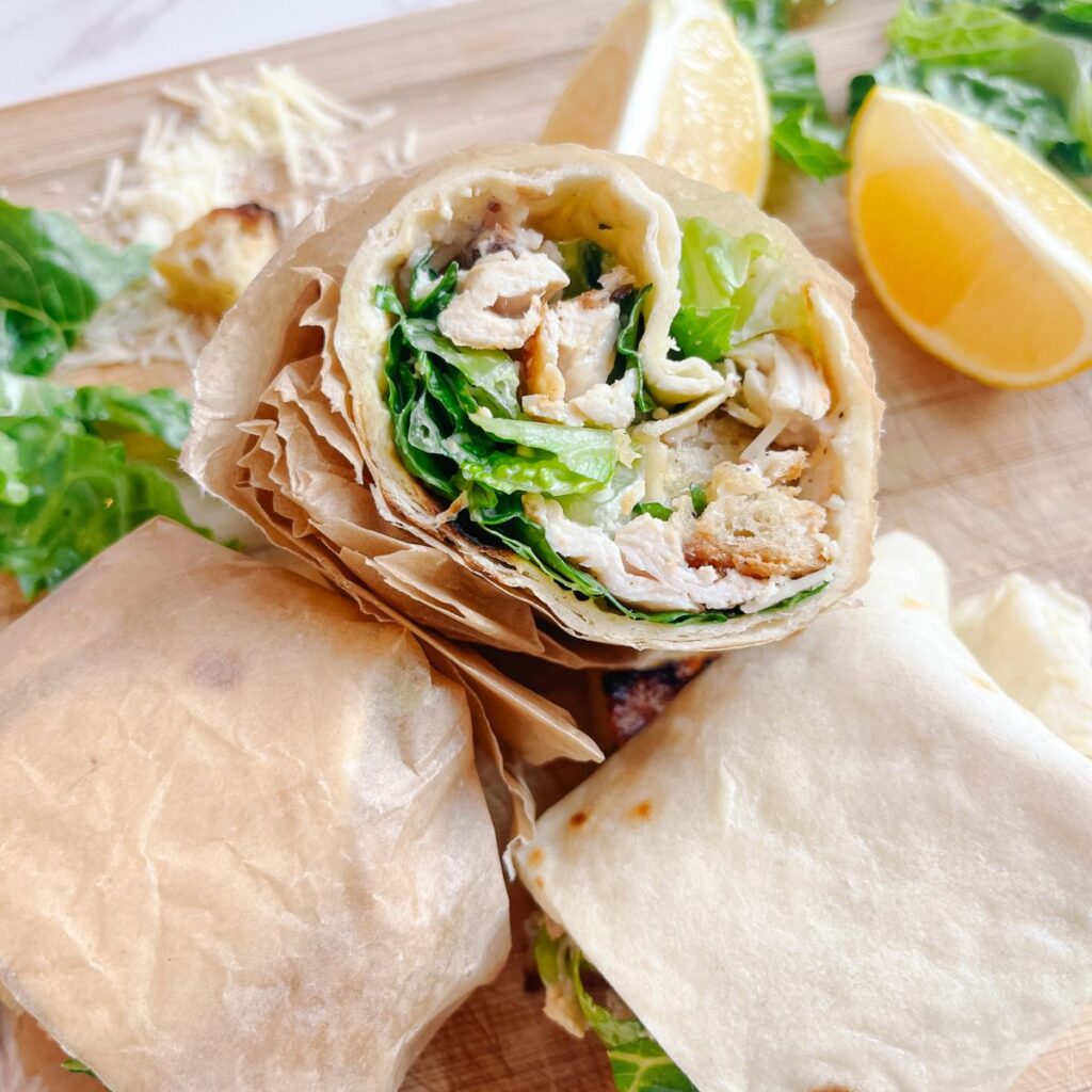 3 halves of a caesar salad wrap.