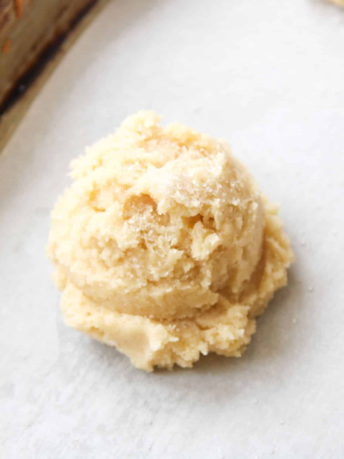 Use a cookie scoop to shape perfectly round cookies on a baking sheet lined with parchment paper.