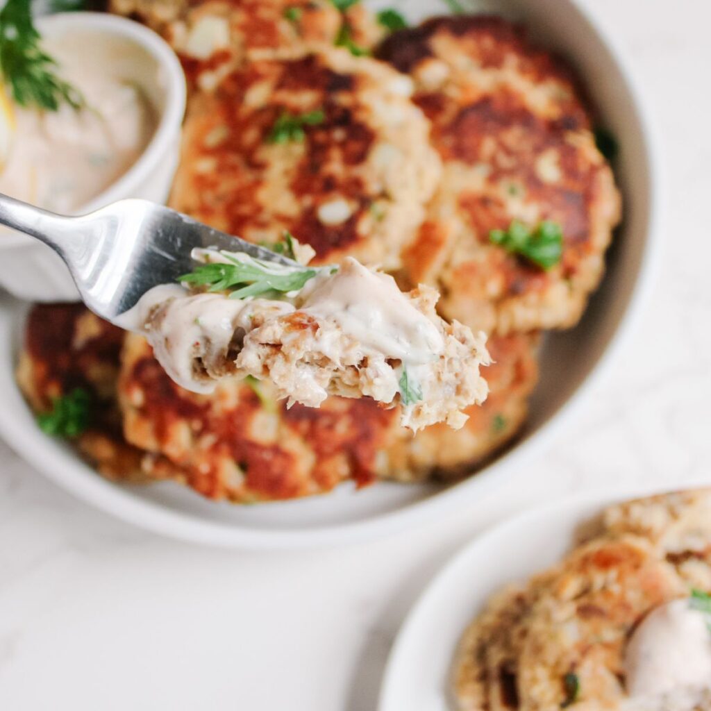 Take a bite of salmon patties after dipping it in the salmon sauce!