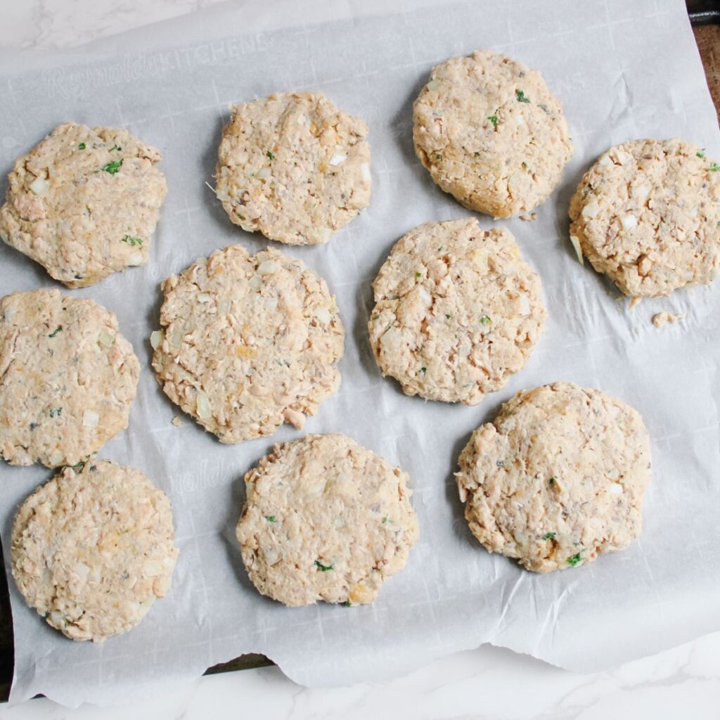 Shape the salmon mixture into round patties and put them on a parchment lined baking tray.