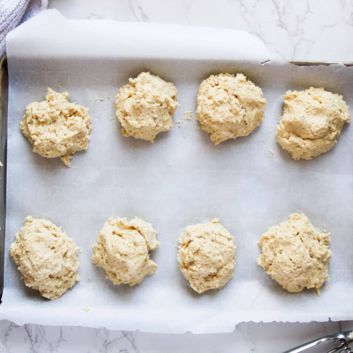 Scoop out the sourdough strawberry shortcake dough in small balls onto a baking sheet lined with parchment paper