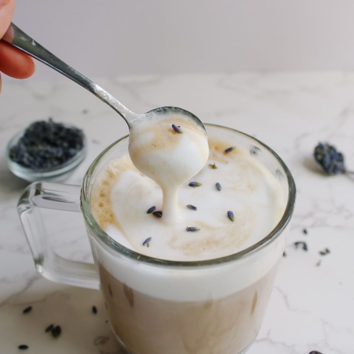 lavender latte with spooned foam