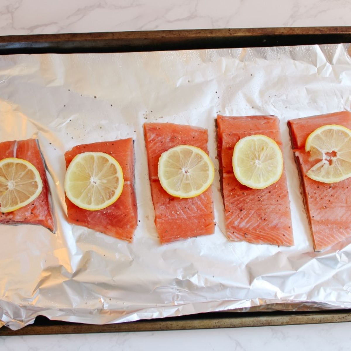 season salmon and place into preheated oven