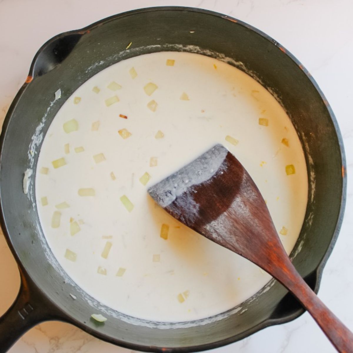 Add chicken broth, heavy cream, lemon juice, and zest into the skillet
