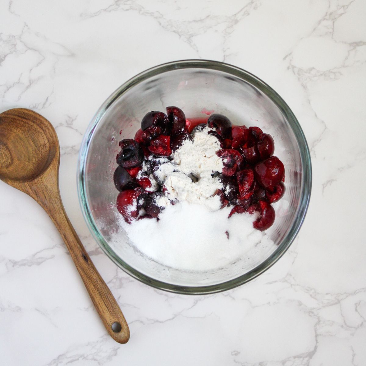 Mix the fresh cherries with flour and sugar.