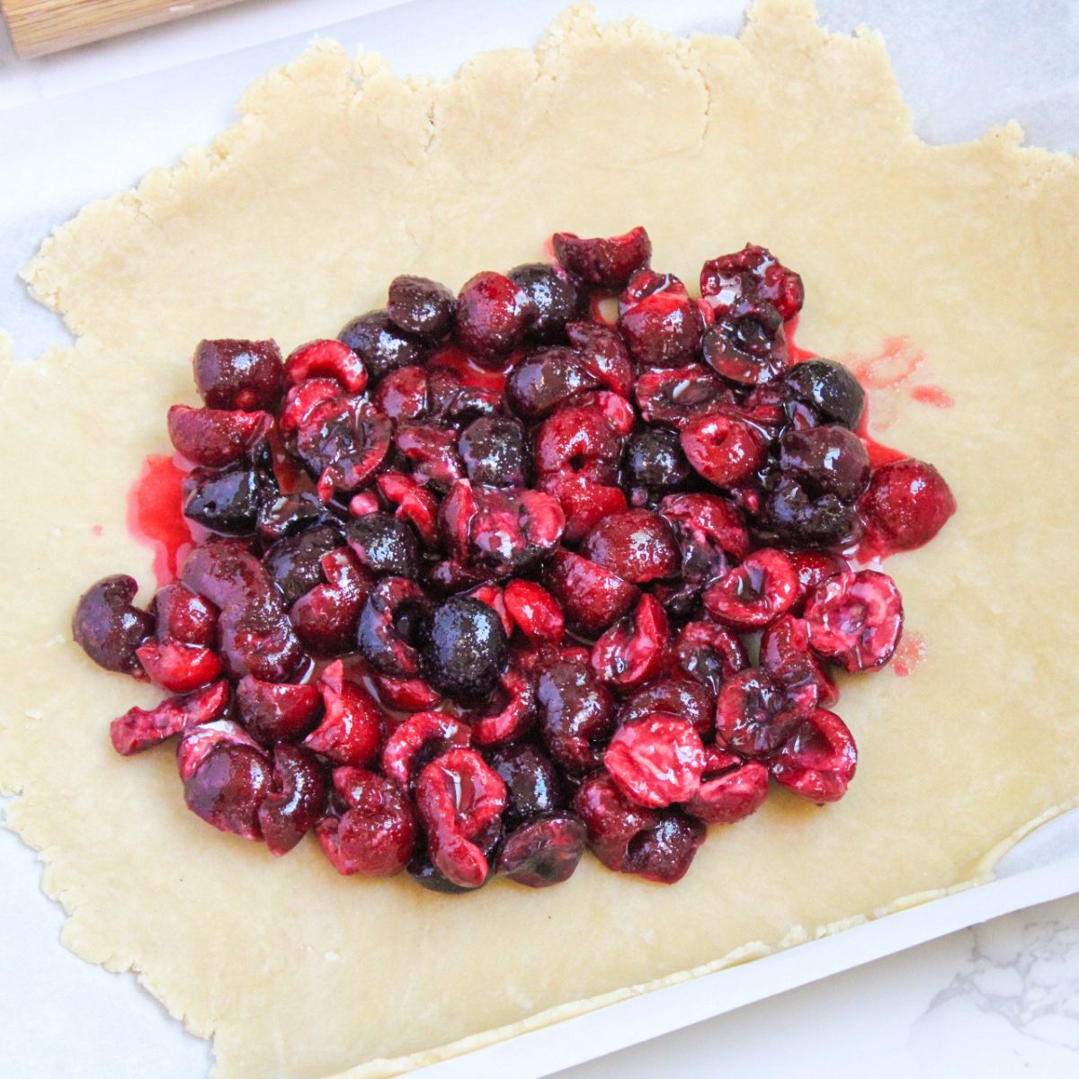 Put the halved cherry mixture into the middle of the pie crust.