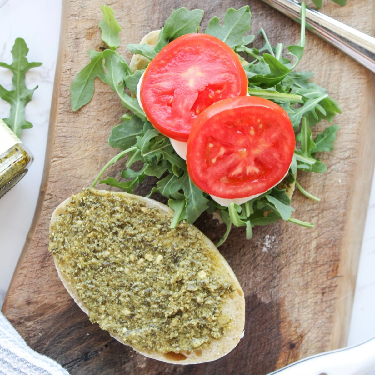 Add tomato slices to the pesto panini.