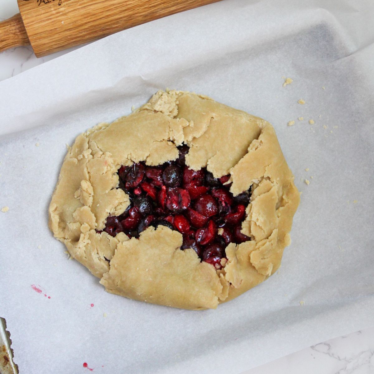 Fold the edges of the pie crust over the galette, leaving a hole in the middle.