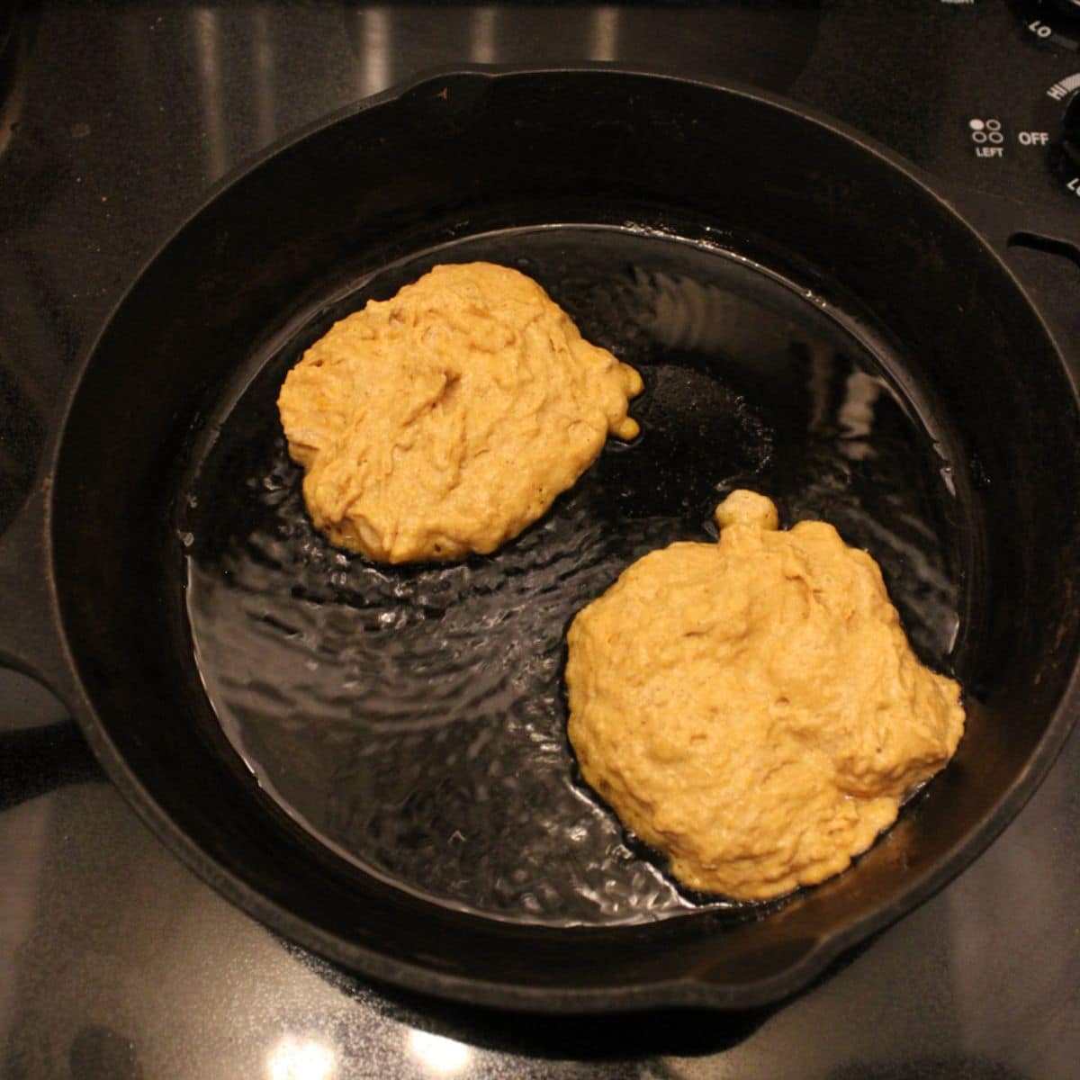 Add the sourdough pumpkin pancake batter to a cast iron skillet with melted butter.