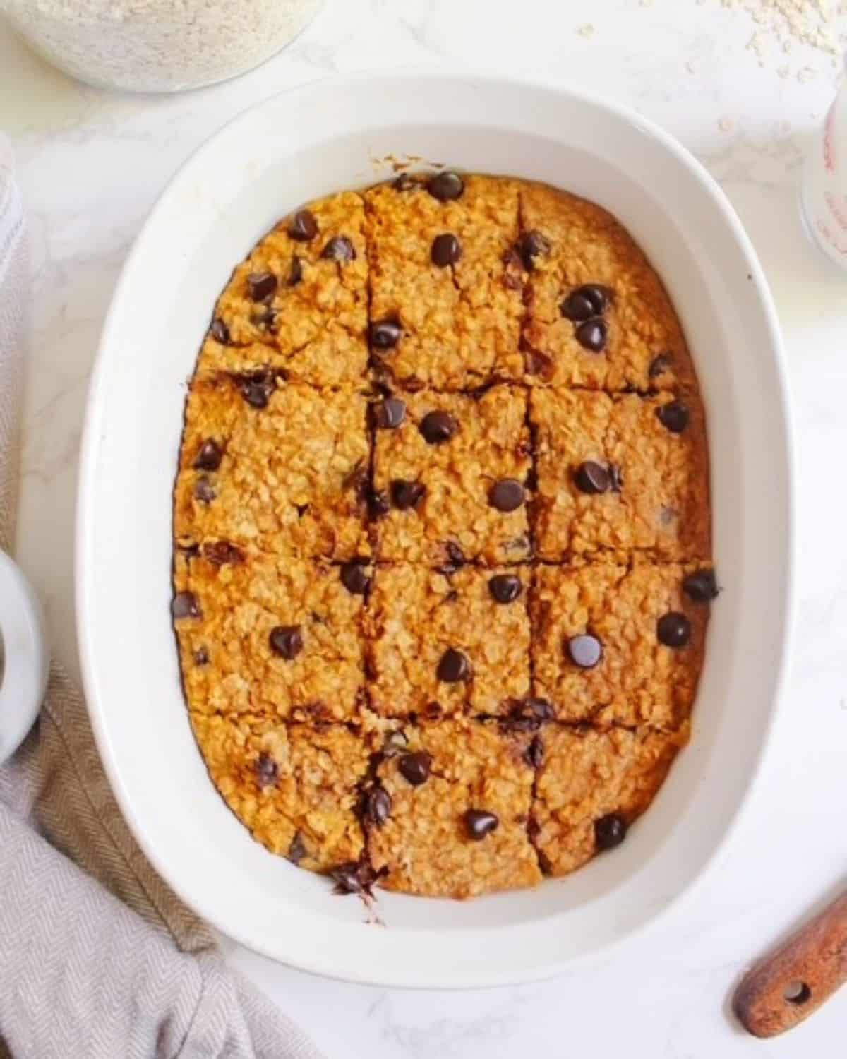 pumpkin baked oatmeal in a white dish cut into squares. 