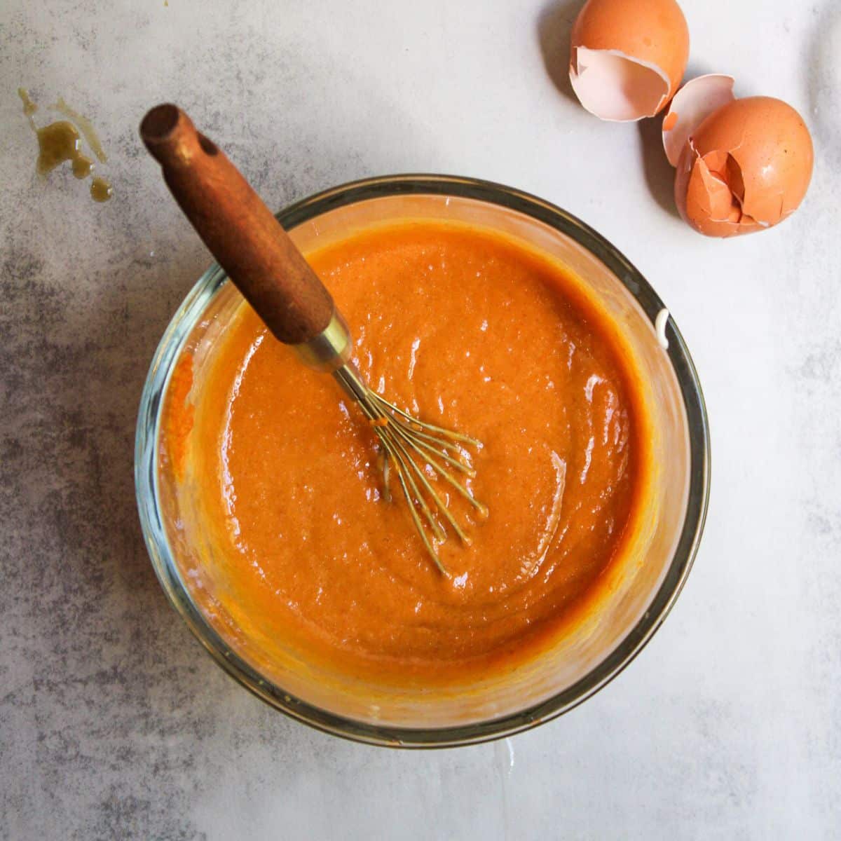 In a large mixing bowl and using a whisk, thoroughly mix the sourdough pumpkin muffin wet ingredients together until the batter is bright orange.