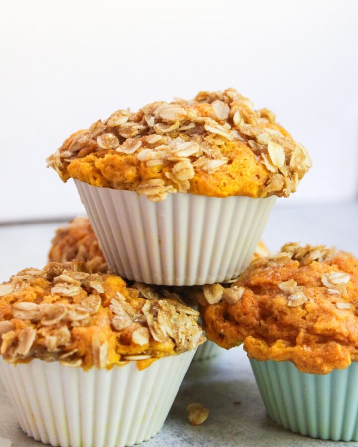 A stack of sourdough pumpkin muffins, freshly baked.