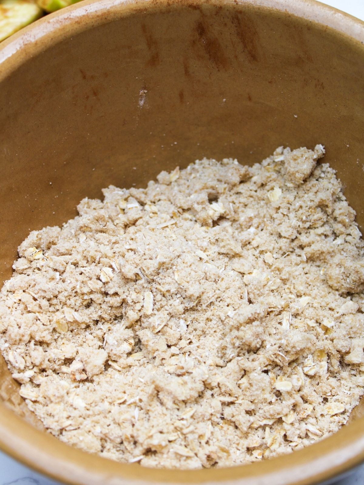 Oat crumble topping in a mixing bowl.