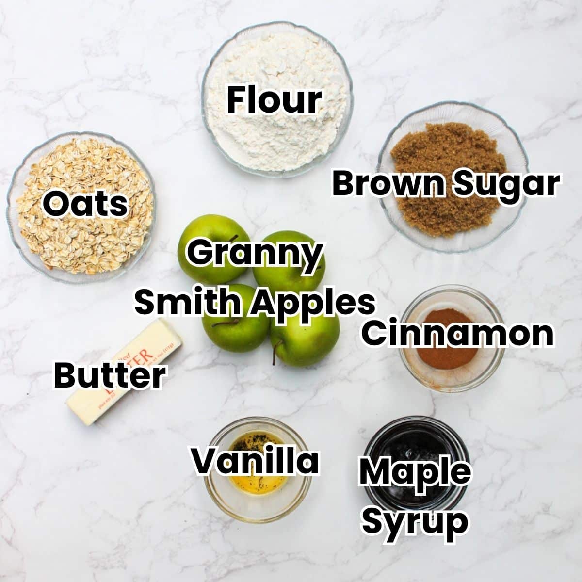Ingredients for apple crisp with oatmeal topping: flour, brown sugar, Granny Smith apples, cinnamon, maple syrup, vanilla, butter and oats.