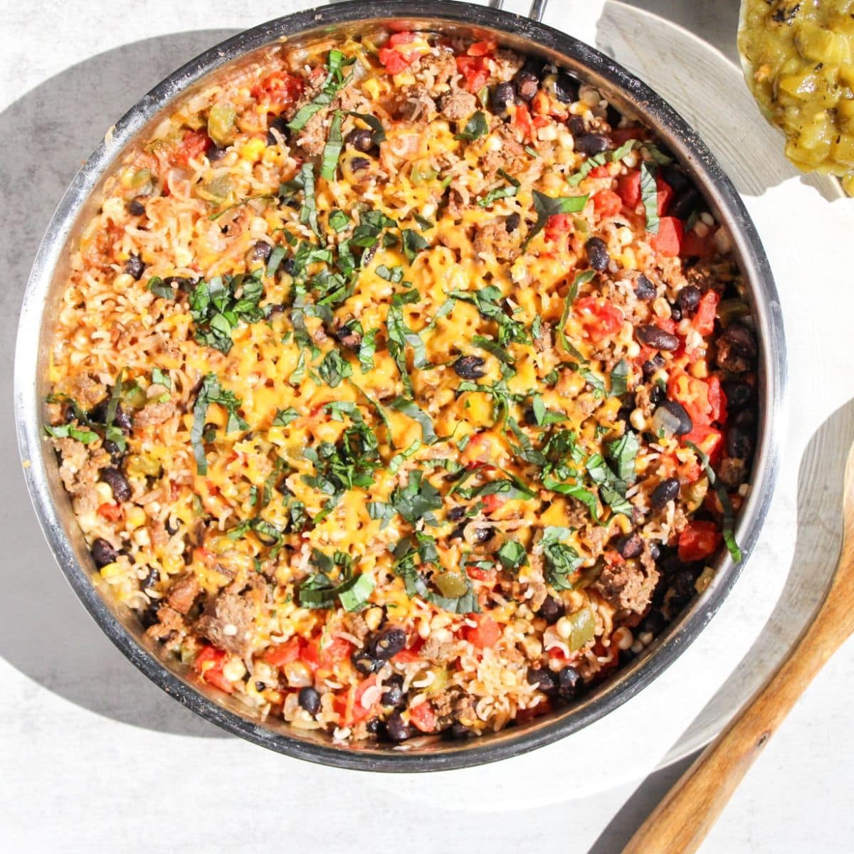 A stainless steel skillet filled with a ground beef taco meal.