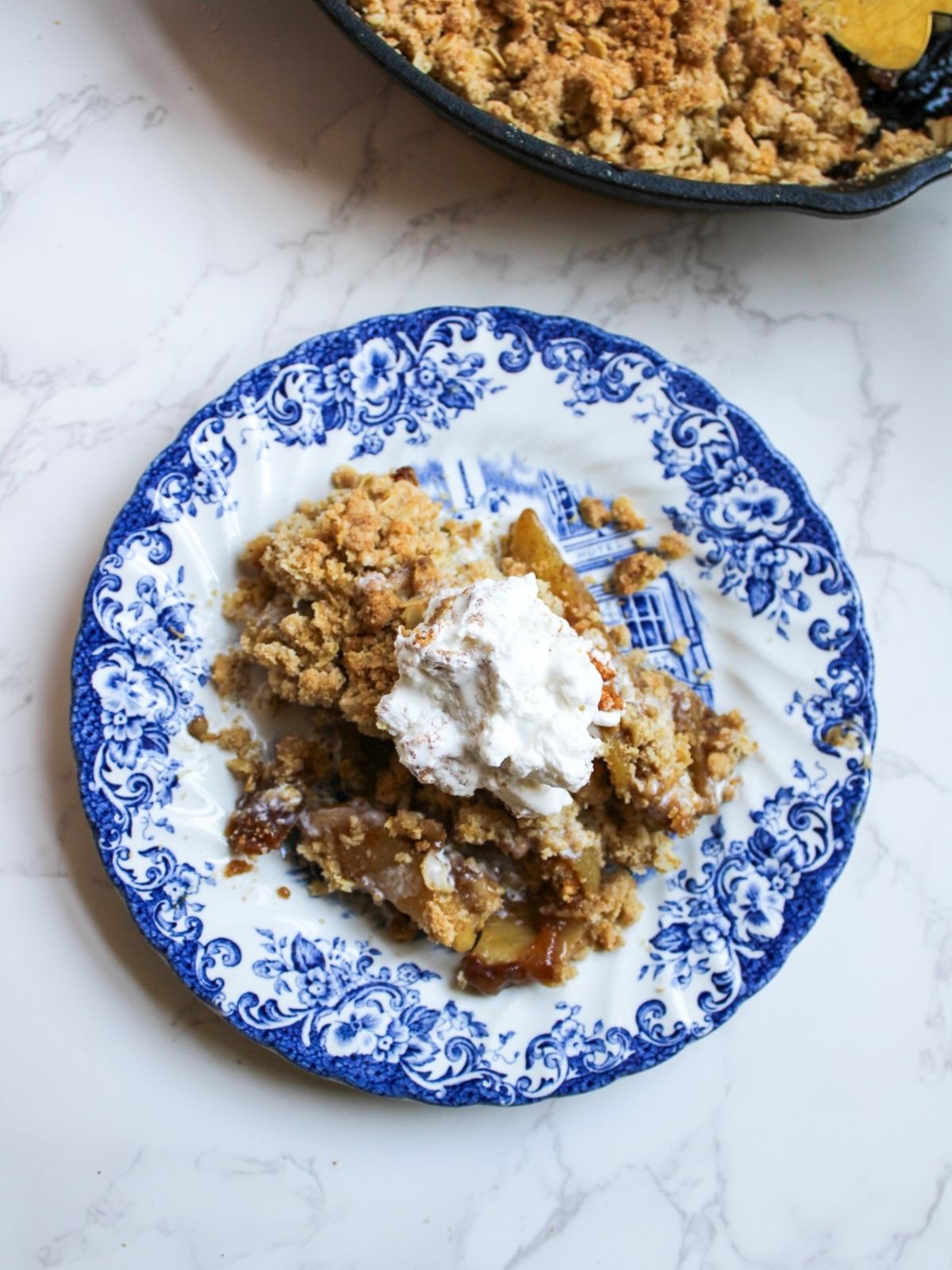 A plate with a single serving of apple crisp.