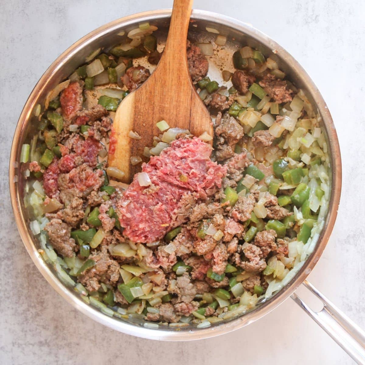 Brown the ground beef in the skillet.