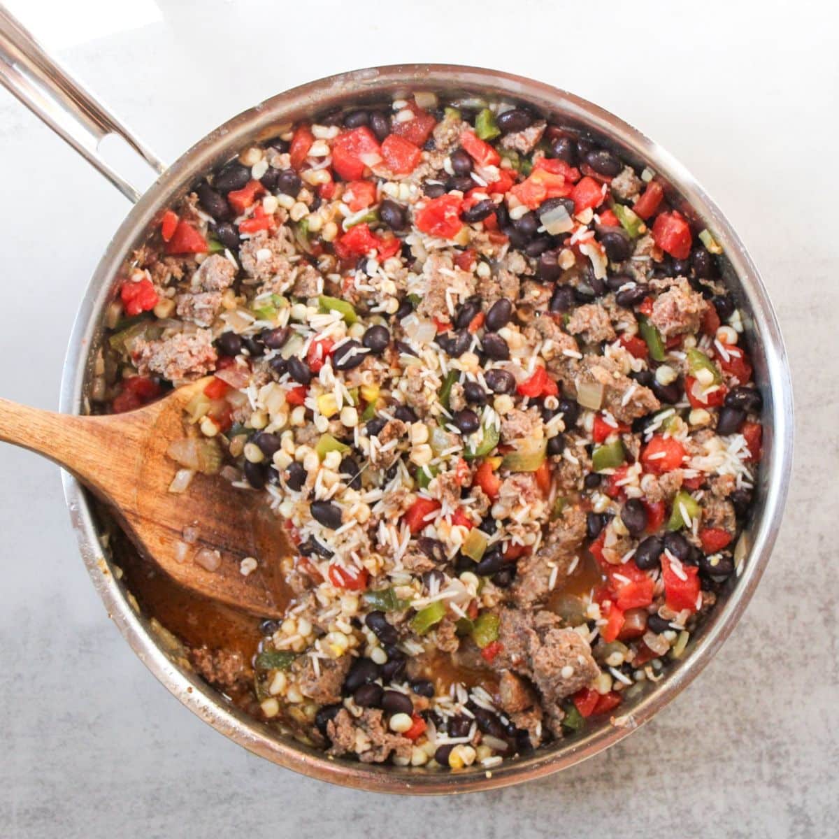 Add the rice to the skillet and cook until soft.